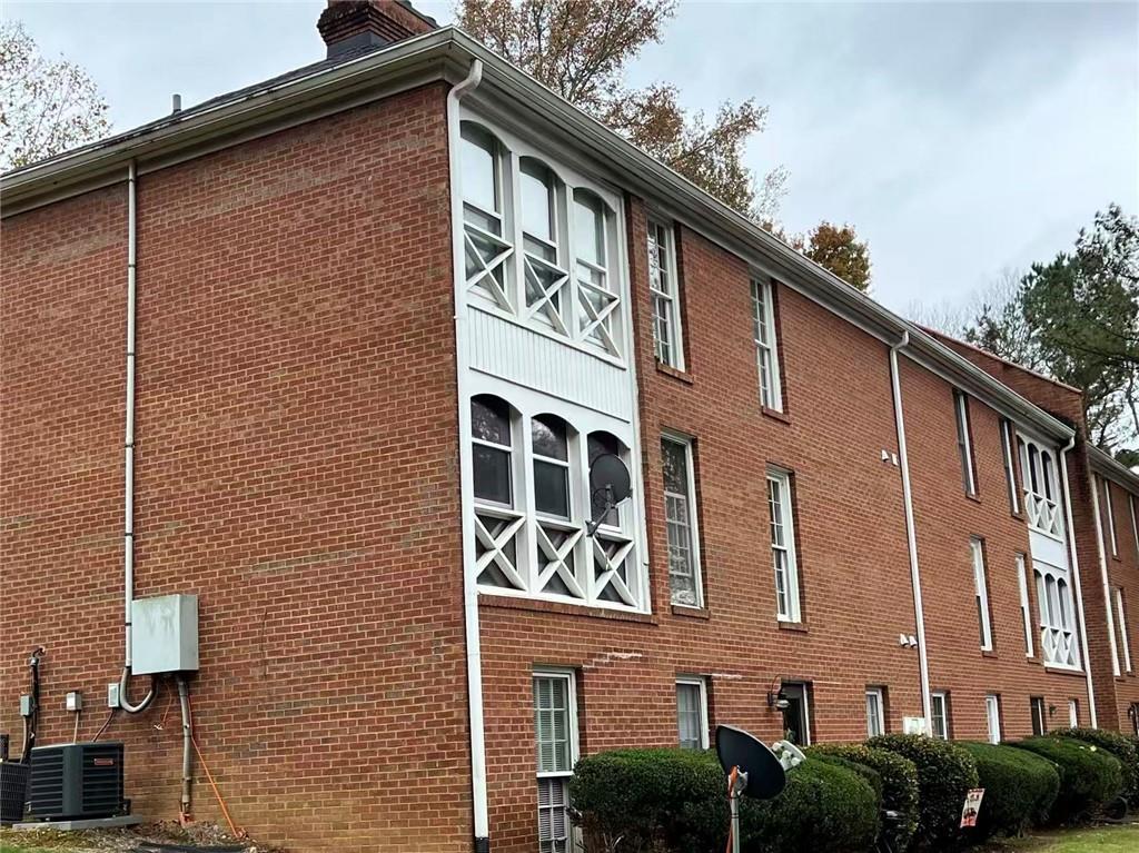 1166 Booth Road Southwest, Unit 908 Marietta, GA 30008 - Photo 30 of 32 a front view of a building with garage and door