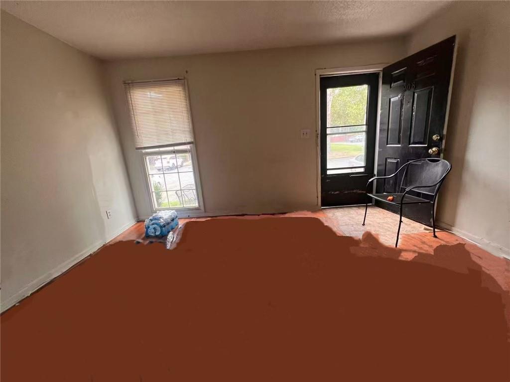 1166 Booth Road Southwest, Unit 908 Marietta, GA 30008 - Photo 6 of 32 a bedroom with a bed table chair and window