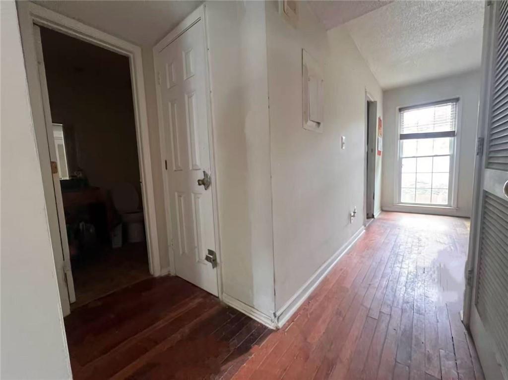 1166 Booth Road Southwest, Unit 908 Marietta, GA 30008 - Photo 7 of 32 an empty room with wooden floor and windows