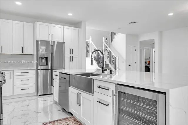 a view of a hallway with wooden floor and entryway