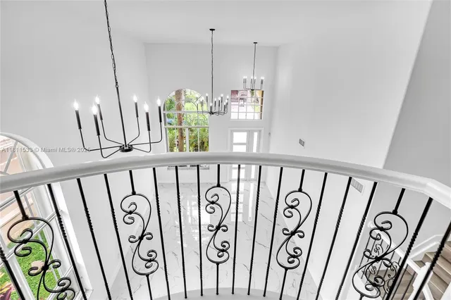 an empty room with wooden floor and a ceiling fan