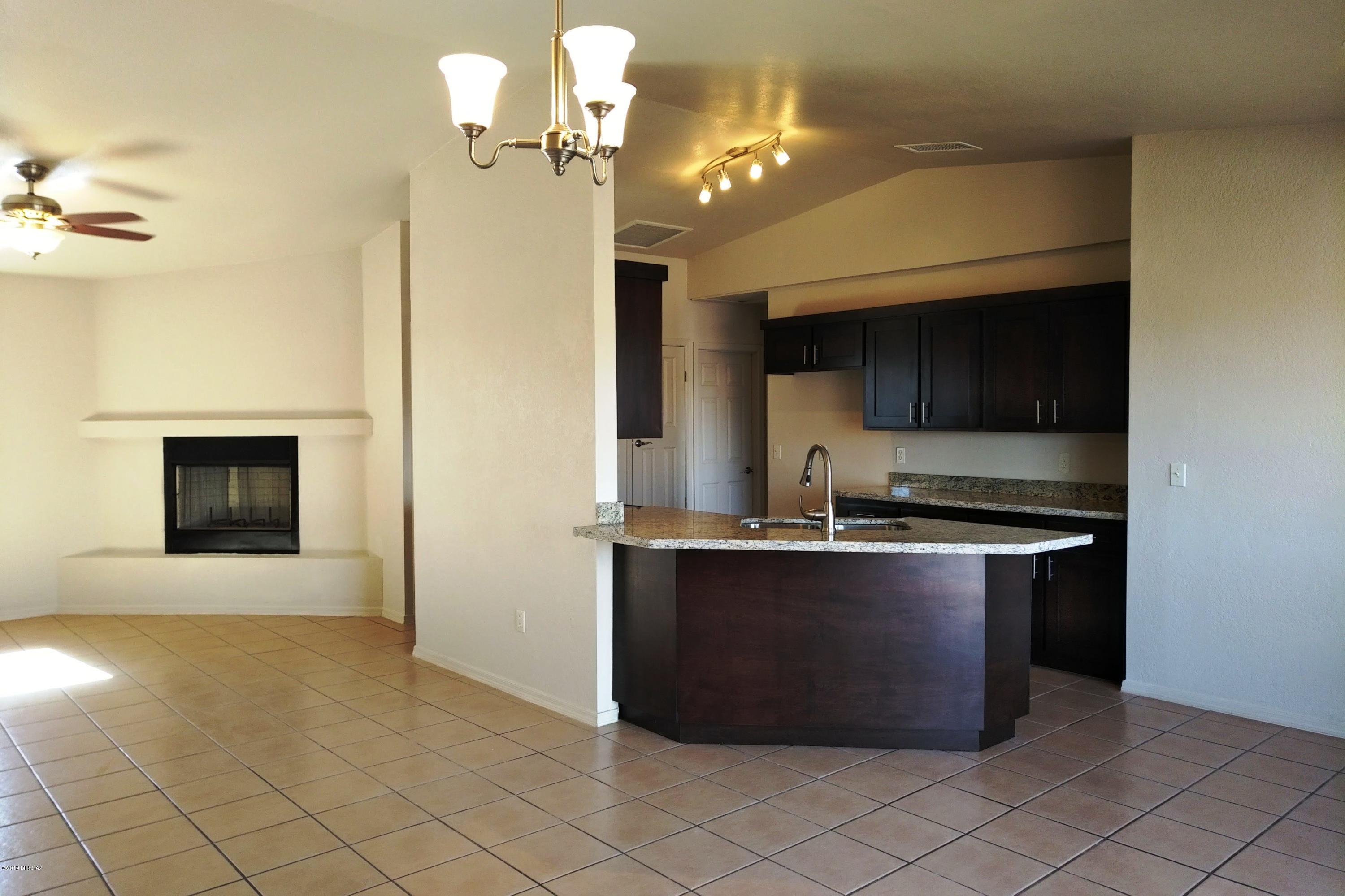 266 Mirto Court Rio Rico, AZ 85648 - Photo 11 of 22 a kitchen with stainless steel appliances a stove a microwave and a refrigerator