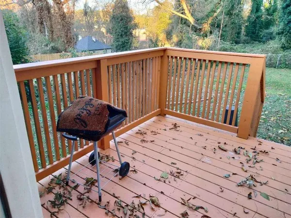 a view of a roof deck with wooden fence and floor