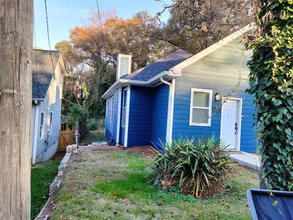a view of a house with a yard and plants