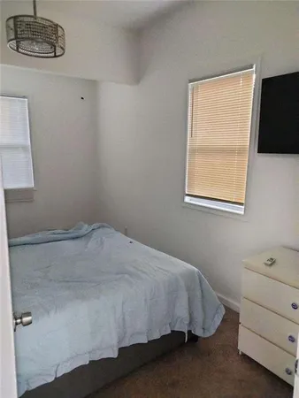 a bedroom with a bed and a tv