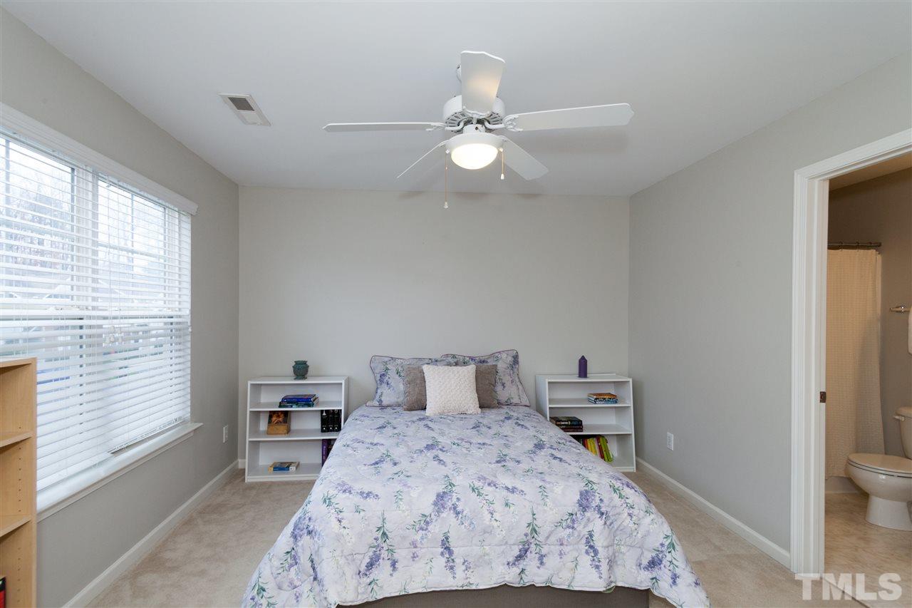 8456 Central Drive Raleigh, NC 27613 - Photo 10 of 25 a bedroom with a bed and a chandelier