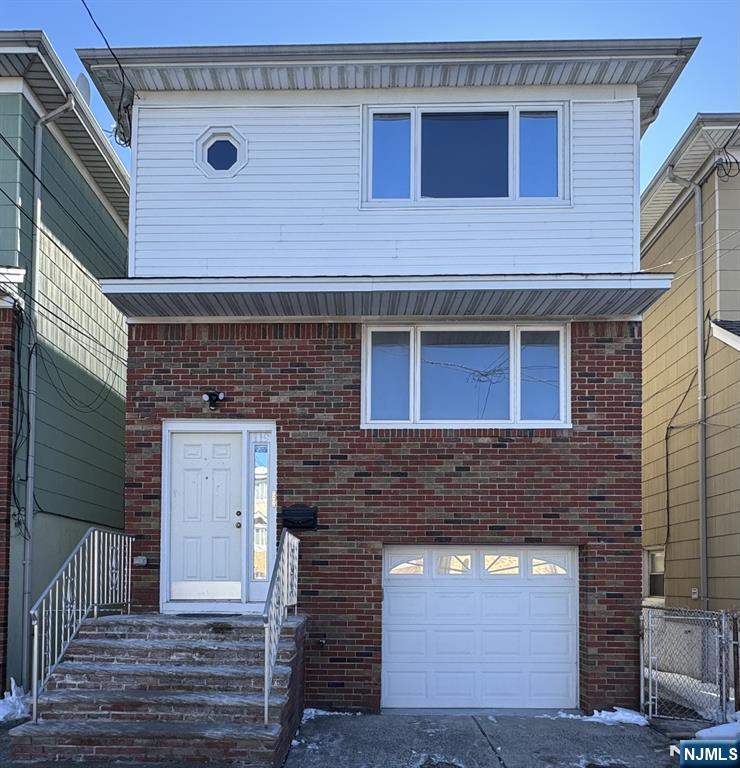 a front view of a house with a garage
