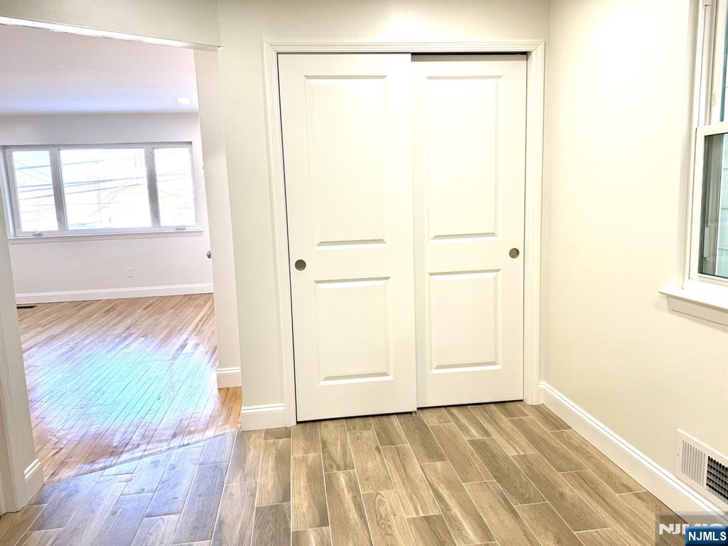 119 Bergen Street Harrison, NJ 07029 - Photo 3 of 13 a view of an empty room with wooden floor