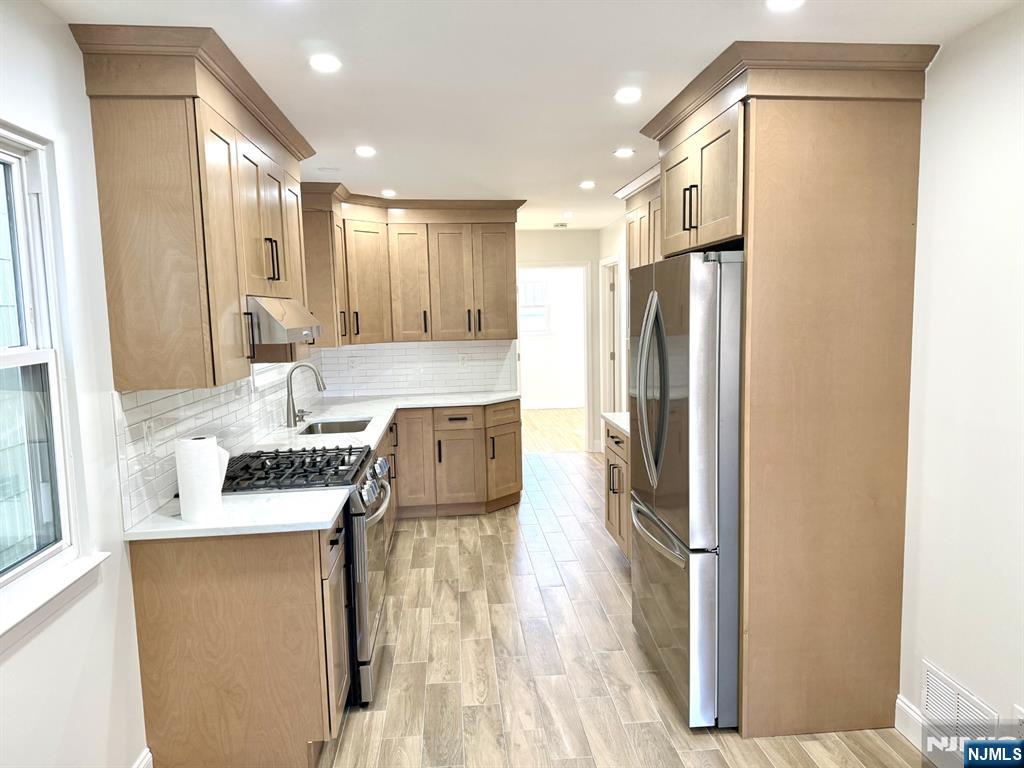 119 Bergen Street Harrison, NJ 07029 - Photo 4 of 13 a kitchen with stainless steel appliances granite countertop a refrigerator and a stove