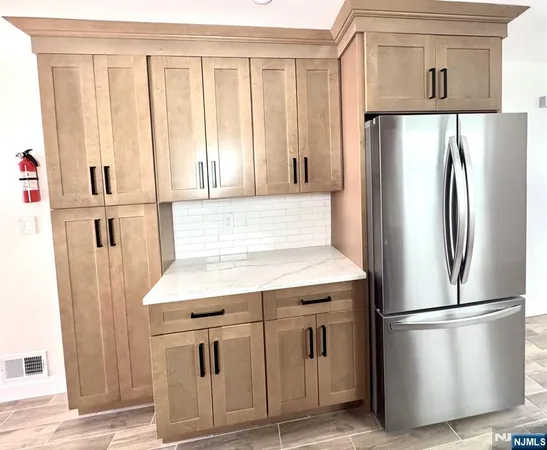a kitchen with stainless steel appliances a refrigerator sink and cabinets