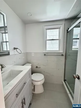 a bathroom with a sink a toilet and window