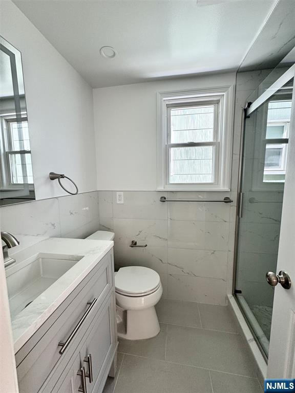 119 Bergen Street Harrison, NJ 07029 - Photo 10 of 13 a bathroom with a sink a toilet and window