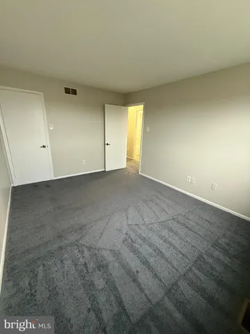 a view of an empty room and a window