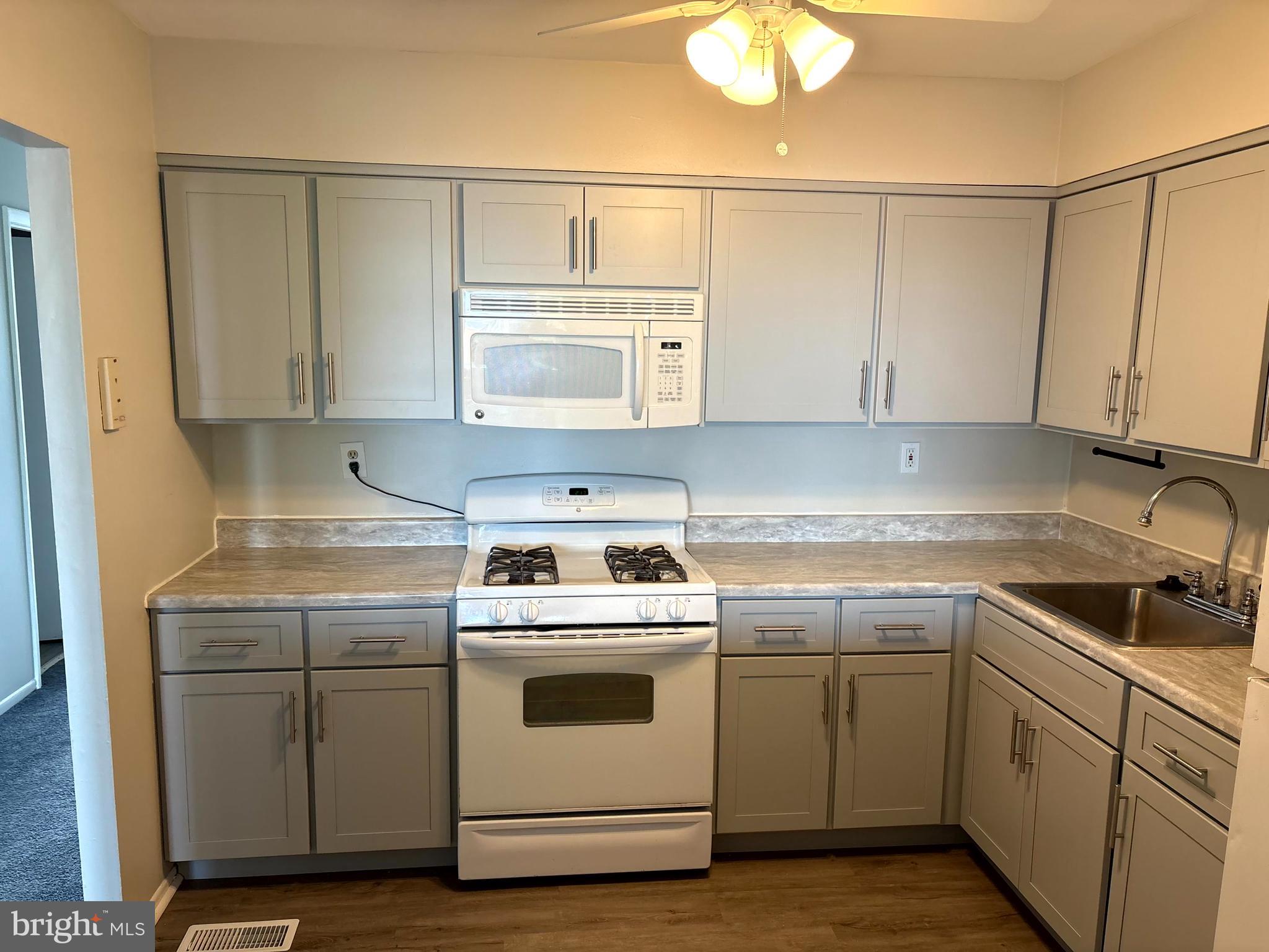 3362 Fairdale Road, Unit 2 Philadelphia, PA 19154 - Photo 14 of 14 a kitchen with a stove sink and cabinets