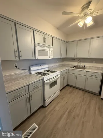 a kitchen with a stove a sink and a refrigerator