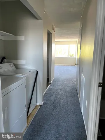 a view of hallway with washer and dryer