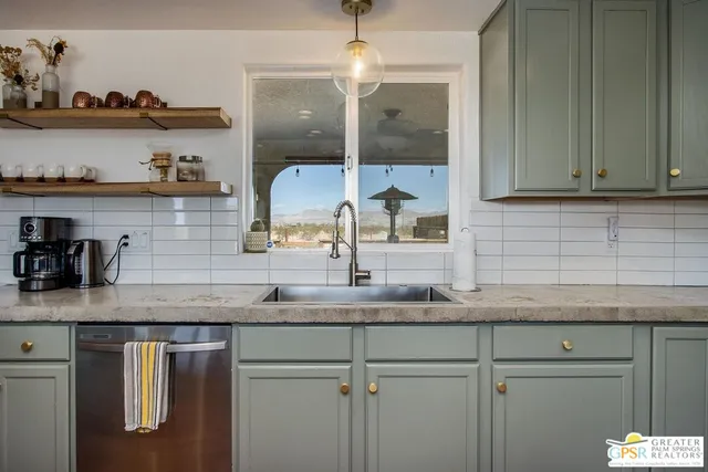 a view of an empty room with wooden floor and staircase