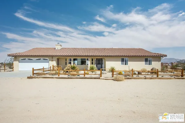 a front view of a house with yard and hallway view