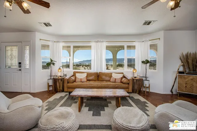 a living room with a fireplace and a flat screen tv