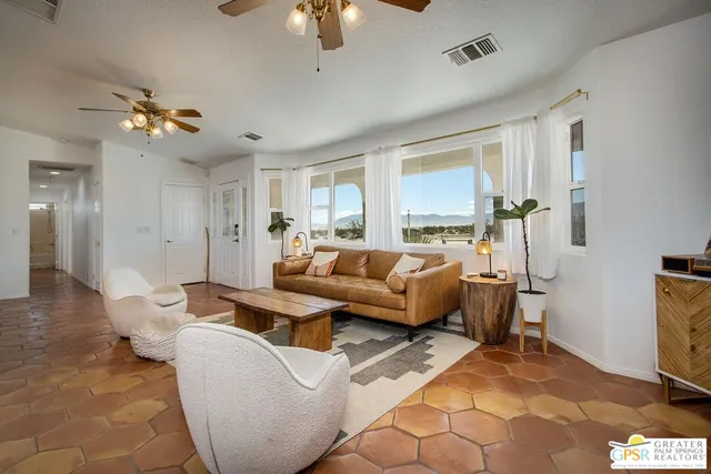 a dining room with furniture and kitchen view