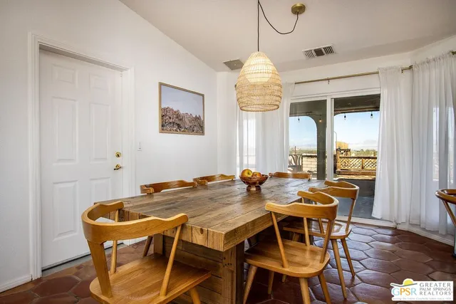 a large kitchen with kitchen island and stainless steel appliances