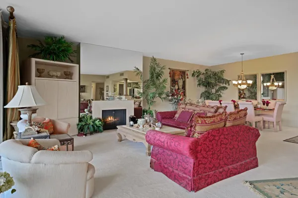 a living room with furniture large window and a fireplace