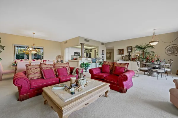 a living room with furniture a rug and a chandelier