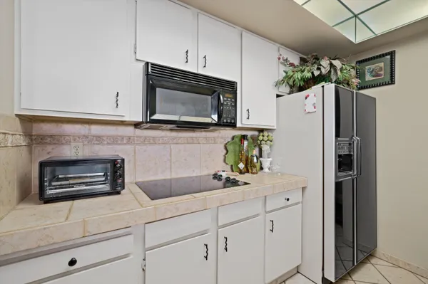 a kitchen with stainless steel appliances a refrigerator sink and microwave