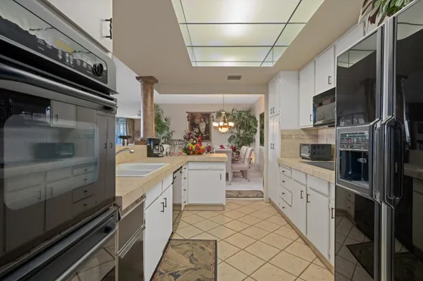 a large kitchen with a stove and cabinets