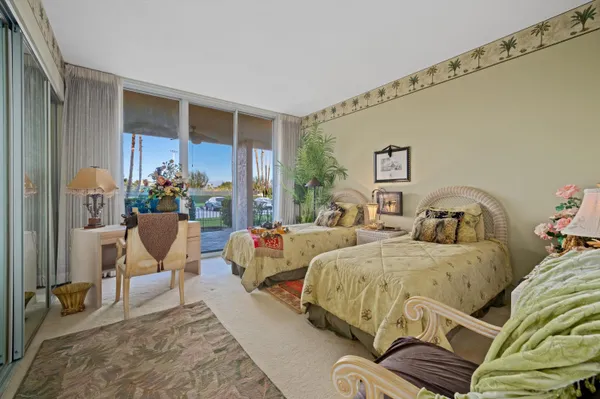 a bedroom with two beds and a couch