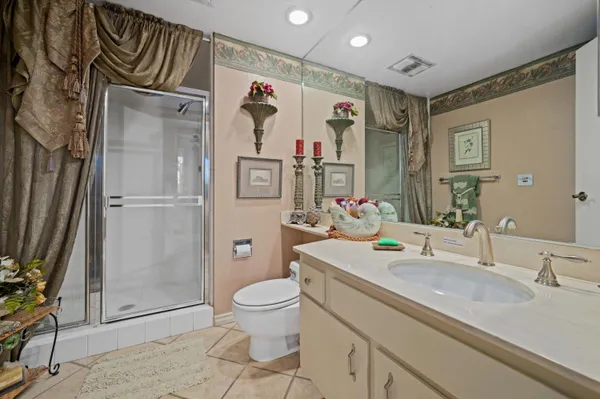 a bathroom with a granite countertop sink toilet and shower