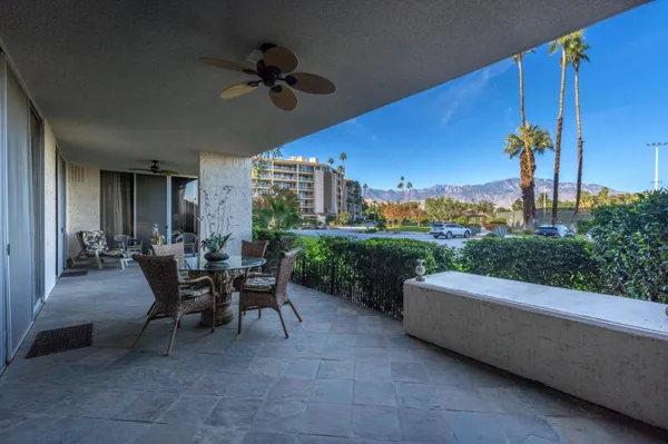 a view of a patio with a dining table and chairs