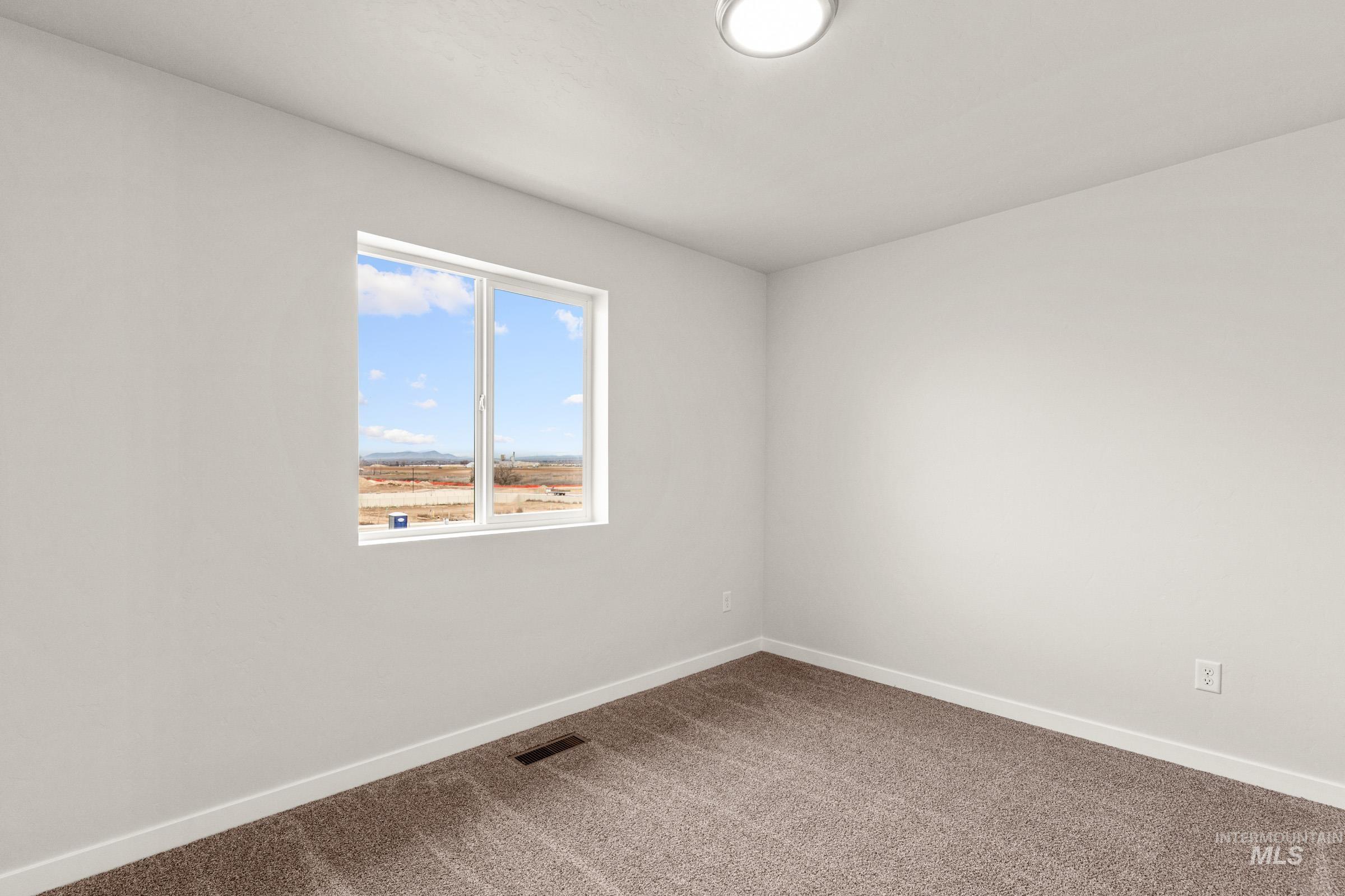 10830 Rutland Street Caldwell, ID 83605 - Photo 11 of 21 Carpeted spare room with baseboards