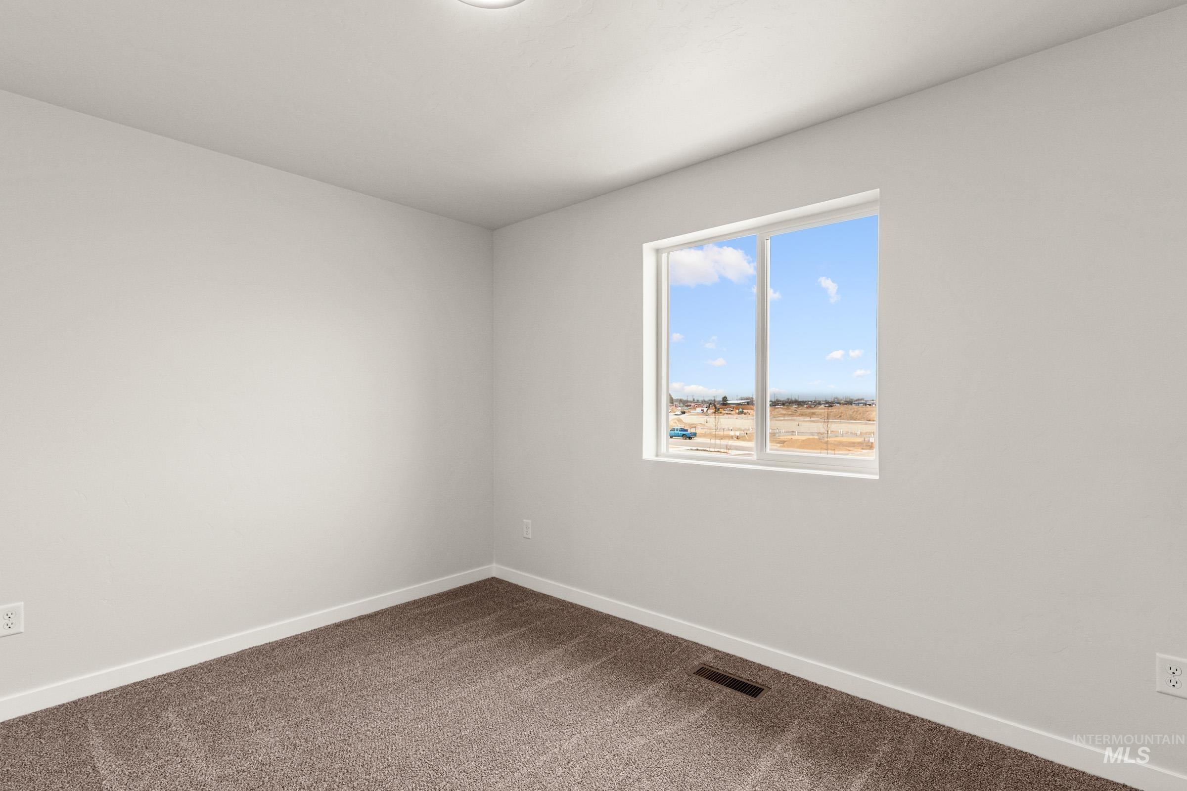 10830 Rutland Street Caldwell, ID 83605 - Photo 12 of 21 Unfurnished room featuring baseboards and dark carpet