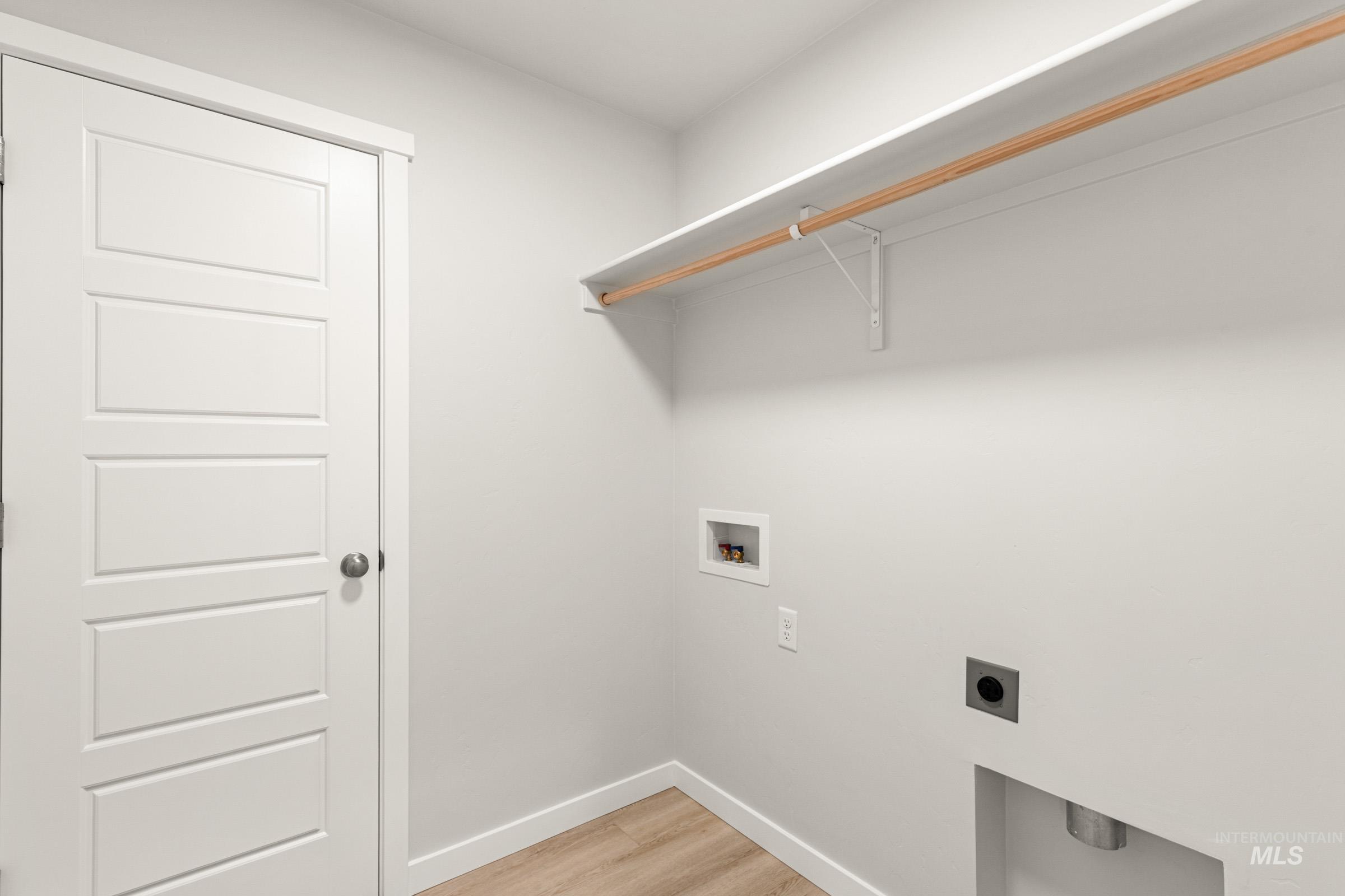 10830 Rutland Street Caldwell, ID 83605 - Photo 14 of 21 Laundry area with light wood-type flooring, hookup for an electric dryer, and hookup for a washing machine