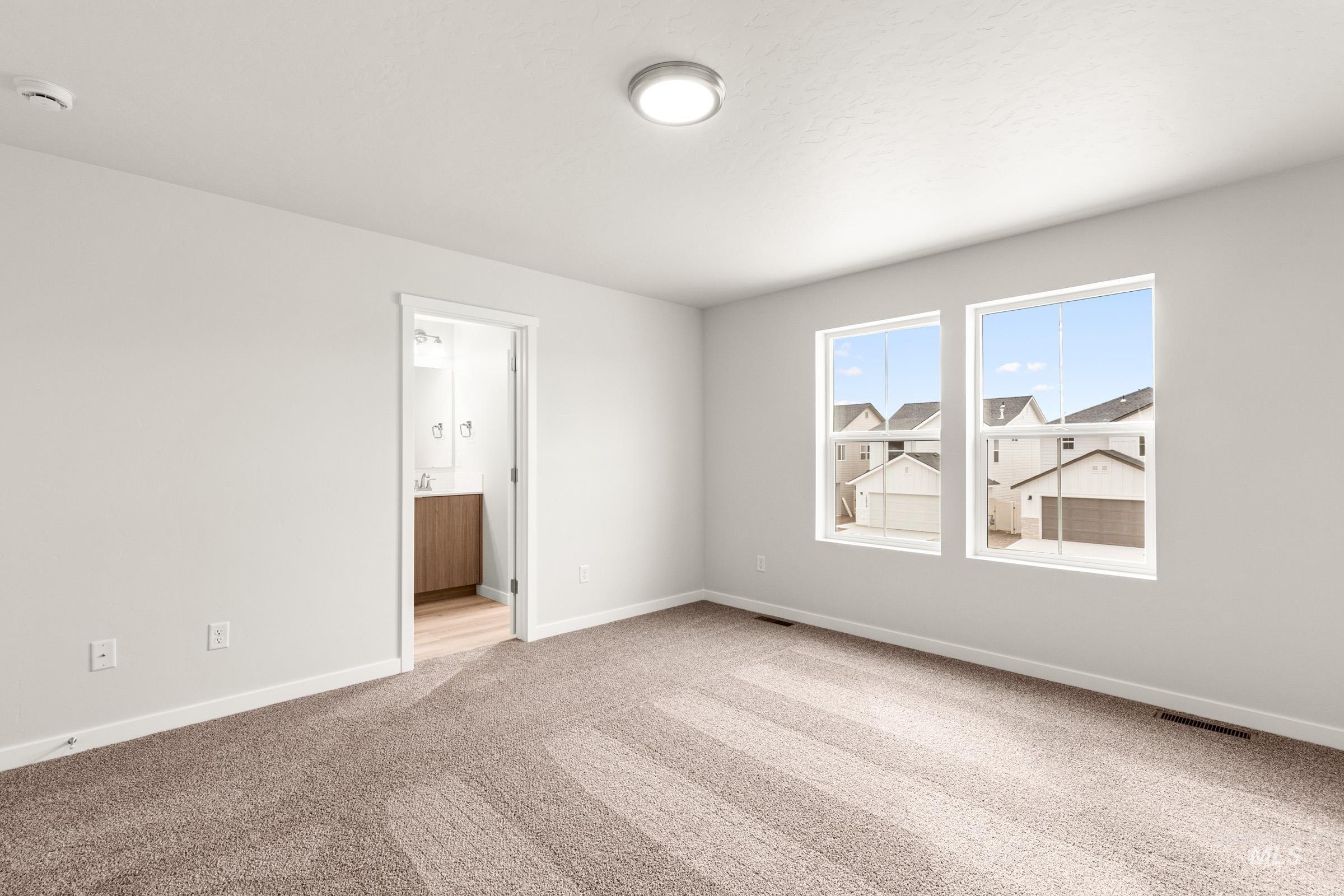 10830 Rutland Street Caldwell, ID 83605 - Photo 15 of 21 Empty room featuring baseboards and light carpet