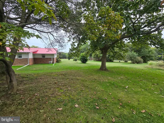 a view of a wooden house with a yard