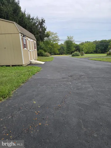 a front view of a house with a yard and a garage