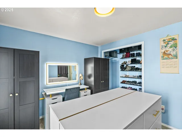 a bathroom with a toilet sink vanity and mirror