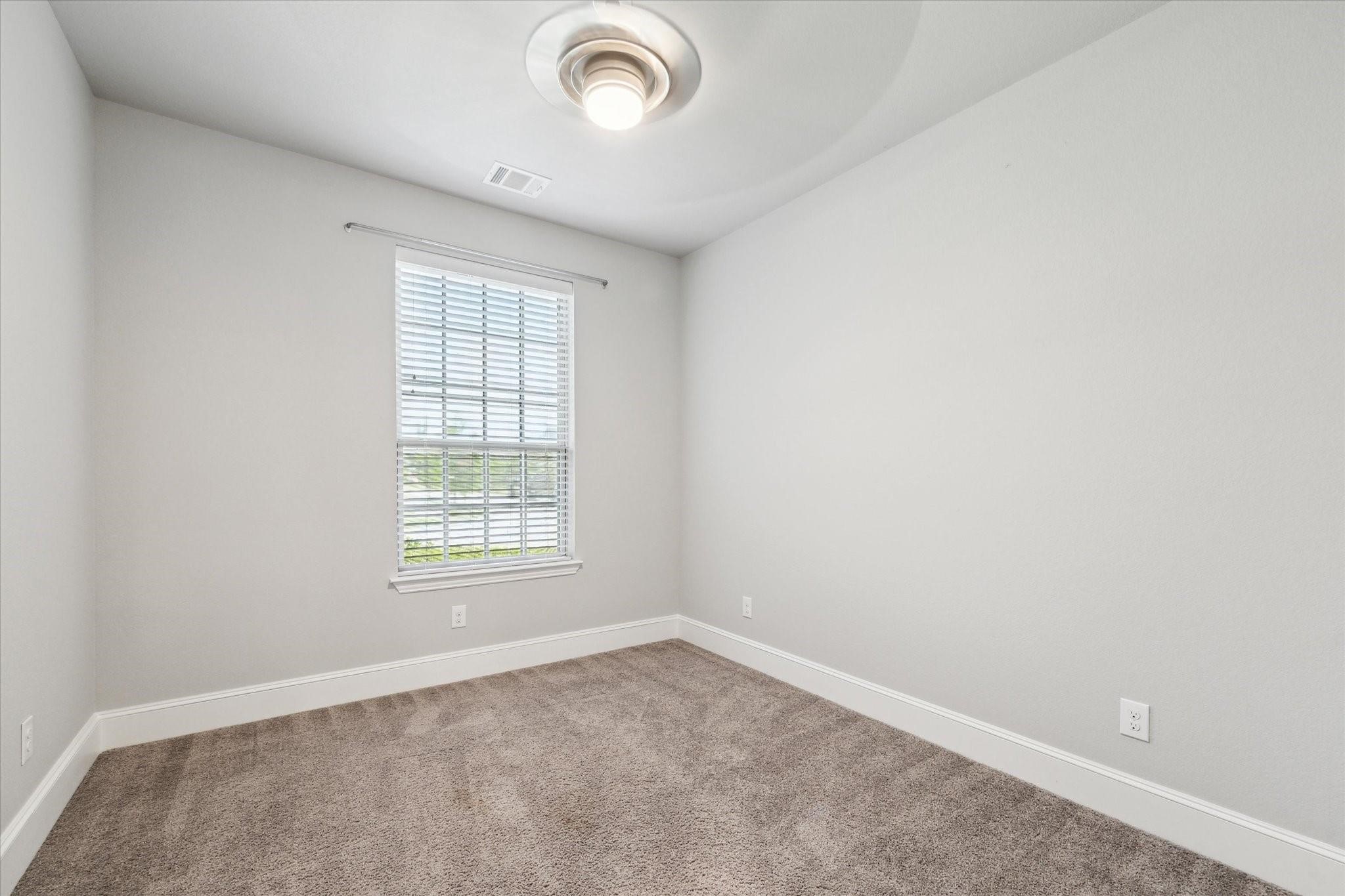 1010 Bat Hawk Court Conroe, TX 77385 - Photo 3 of 50 an empty room with a empty space and windows