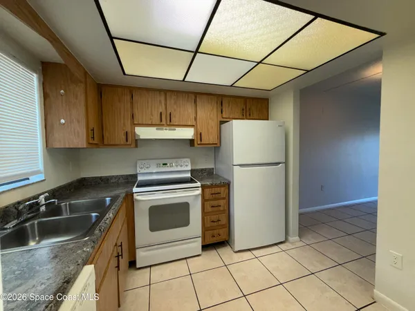 a view of a hallway with wooden shelves