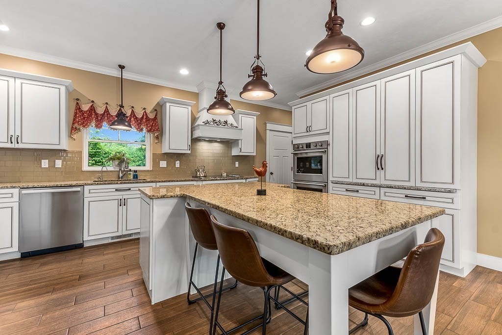 196 Glenwood Road Rutland, MA 01543 - Photo 13 of 37 a kitchen with kitchen island granite countertop wooden cabinets and a refrigerator