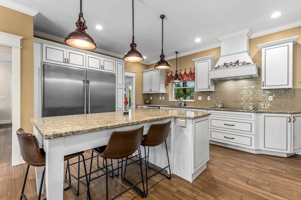196 Glenwood Road Rutland, MA 01543 - Photo 14 of 37 a kitchen with kitchen island granite countertop a sink a counter space appliances and cabinets