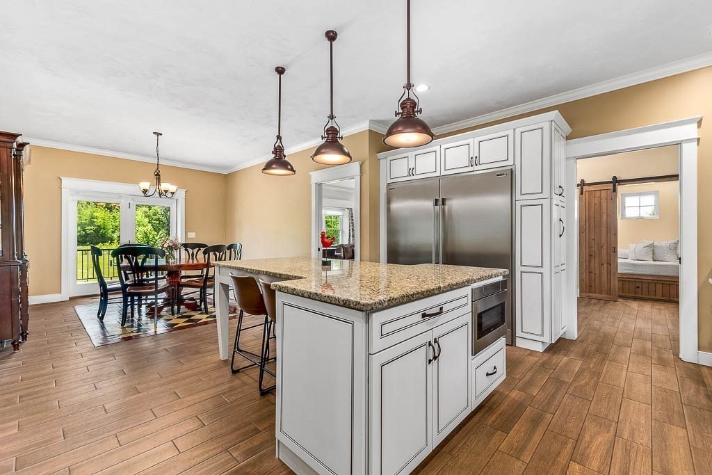 196 Glenwood Road Rutland, MA 01543 - Photo 16 of 37 a open kitchen with stainless steel appliances granite countertop wooden floors and white cabinets