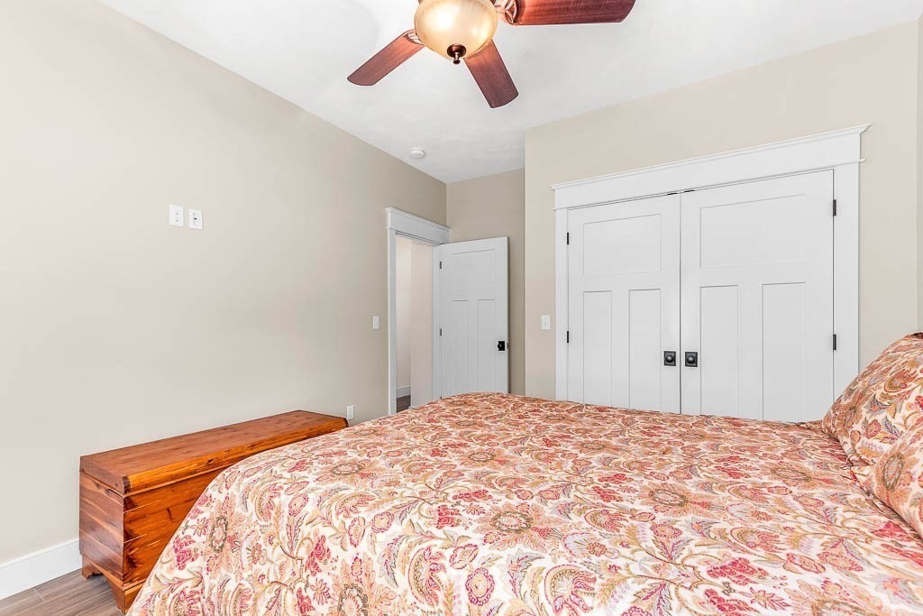 196 Glenwood Road Rutland, MA 01543 - Photo 24 of 37 a bedroom with a large bed and a chandelier