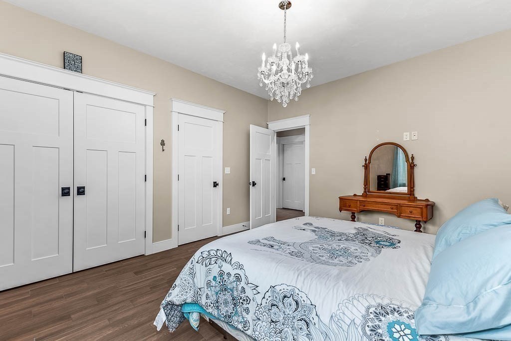 196 Glenwood Road Rutland, MA 01543 - Photo 26 of 37 a bedroom with a bed and a chandelier