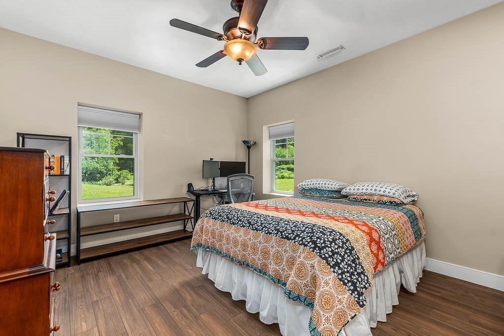 196 Glenwood Road Rutland, MA 01543 - Photo 27 of 37 a bedroom with a bed and a chandelier