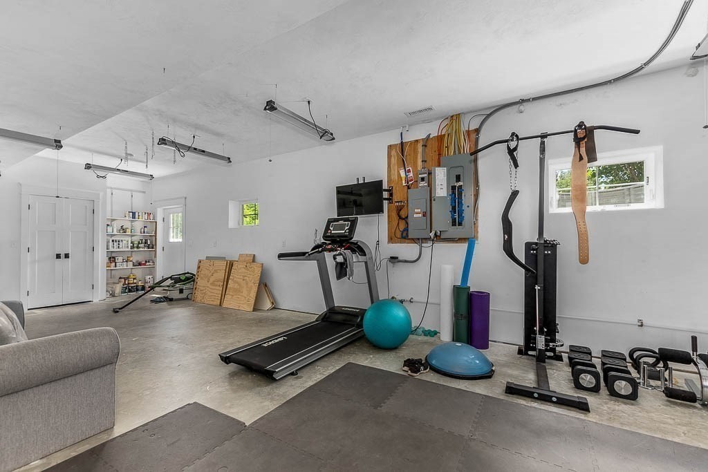 196 Glenwood Road Rutland, MA 01543 - Photo 31 of 37 a living room with furniture gym equipment and a window