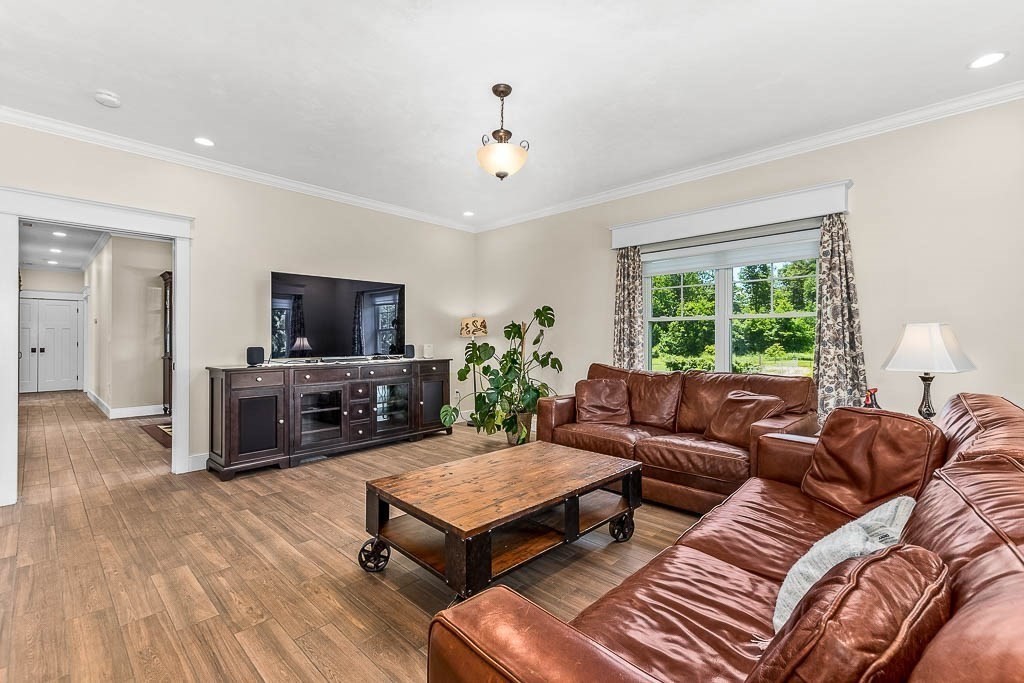 196 Glenwood Road Rutland, MA 01543 - Photo 9 of 37 a living room with furniture a flat screen tv and a large window