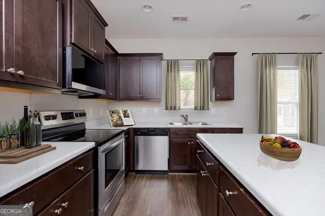 a view of a kitchen area with furniture and wooden floor
